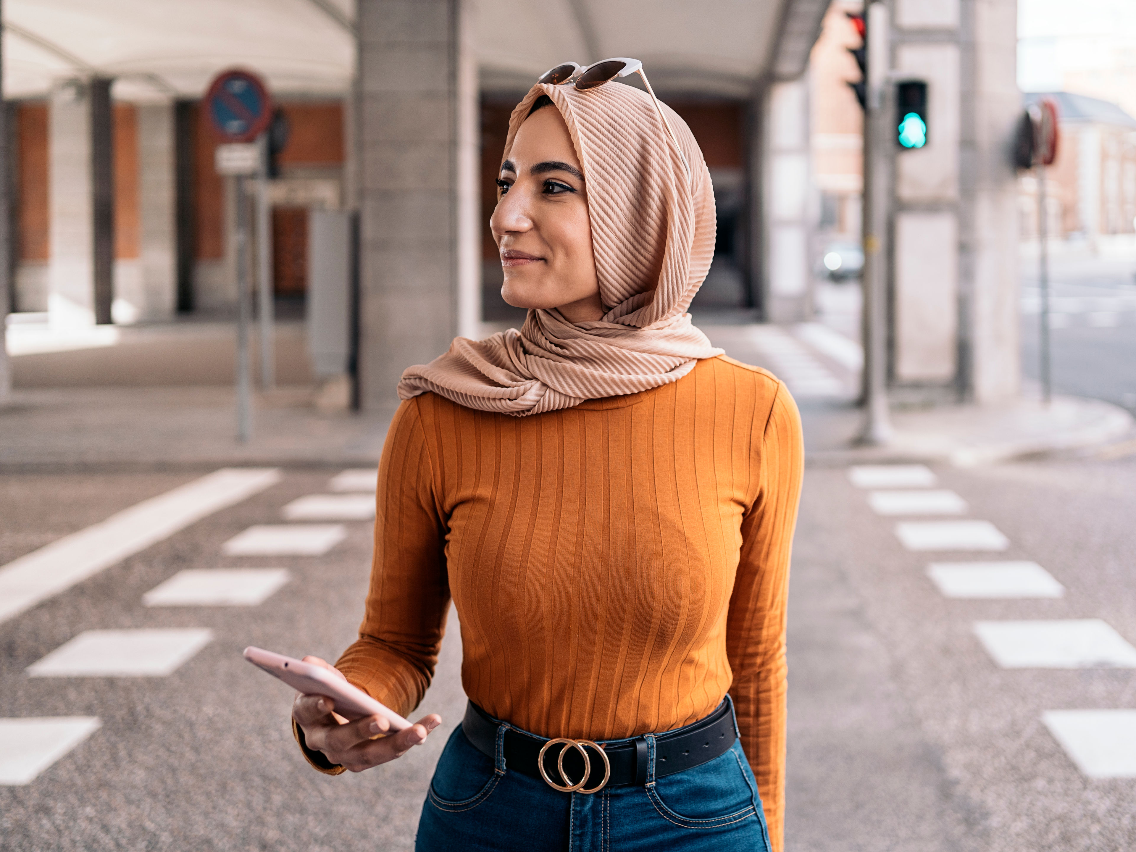 A woman wearing an orange top