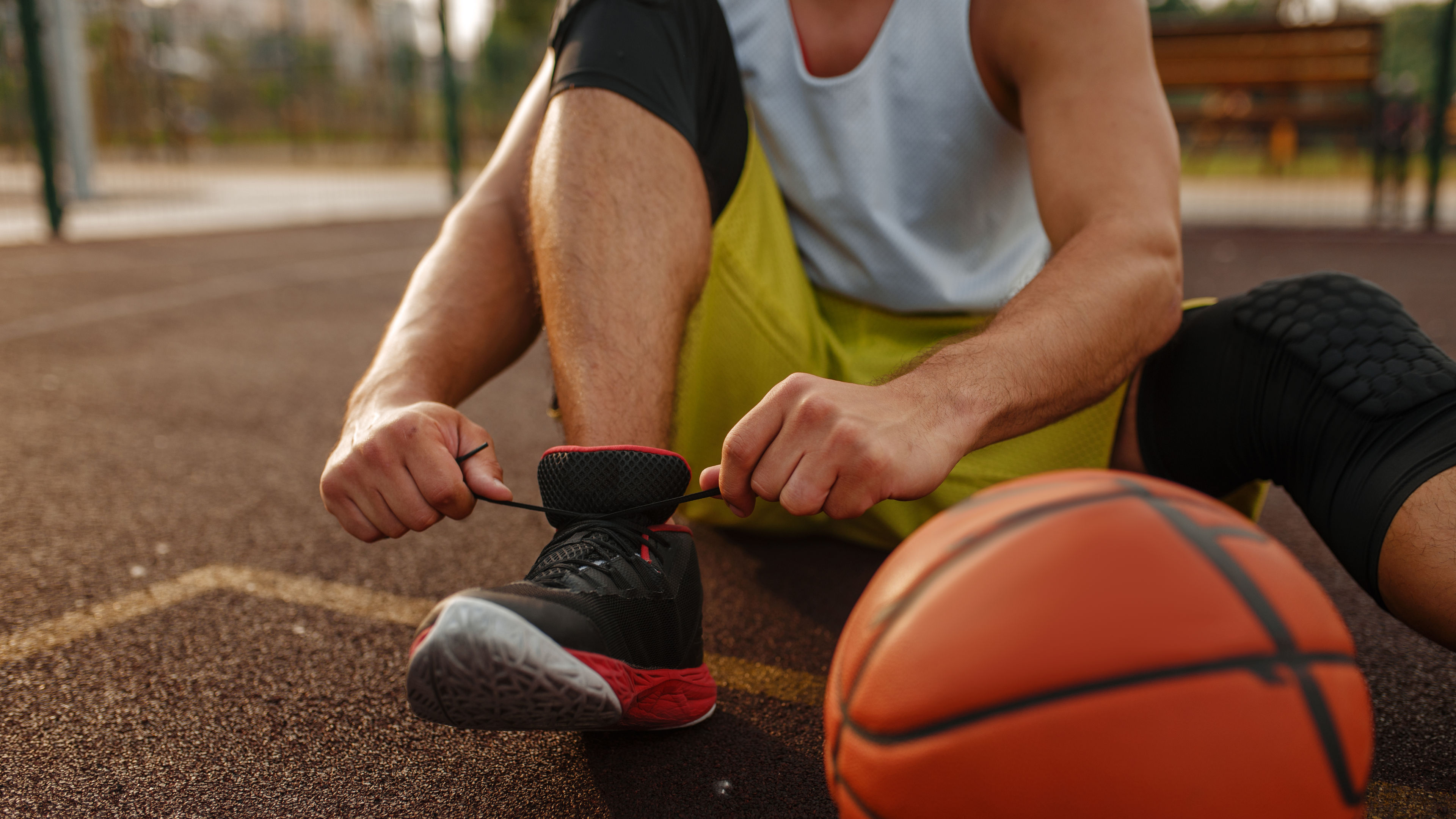 Basketball player tying laces