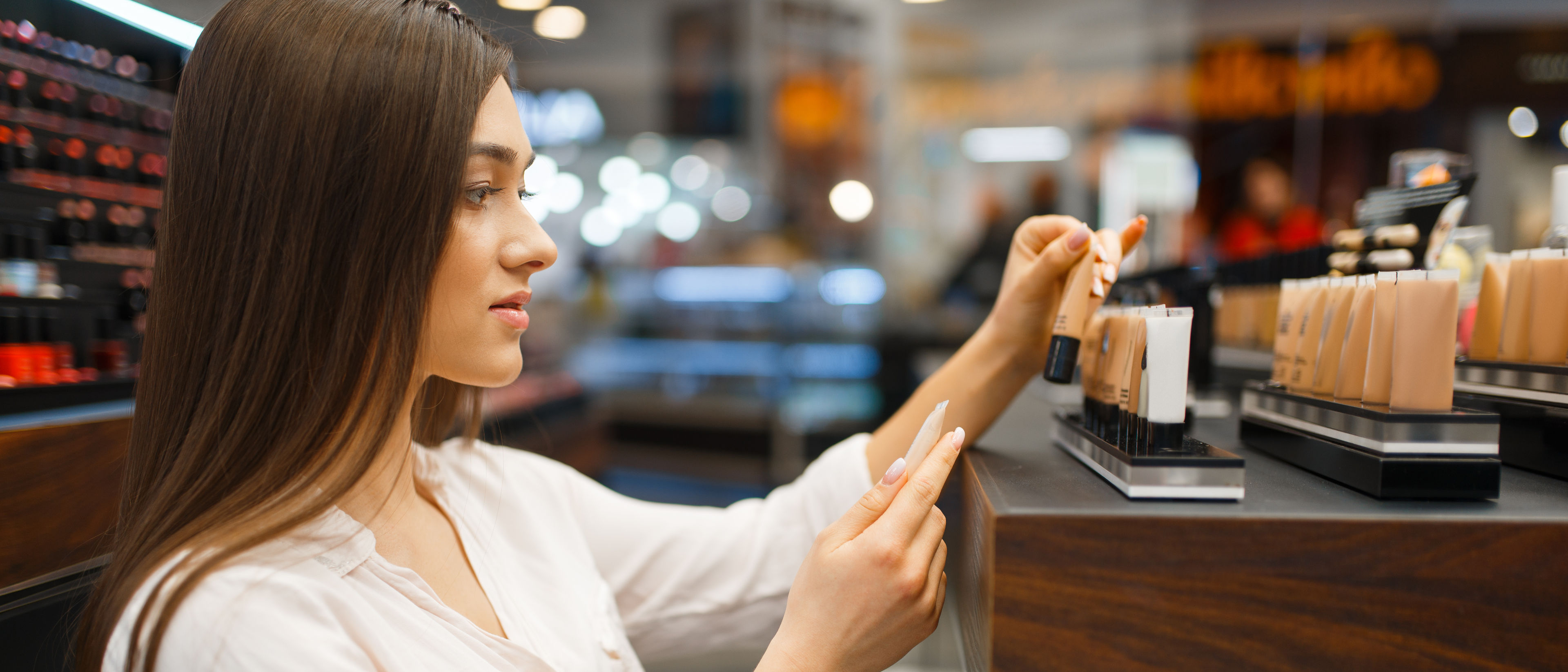 Woman taking body cream from the shelf