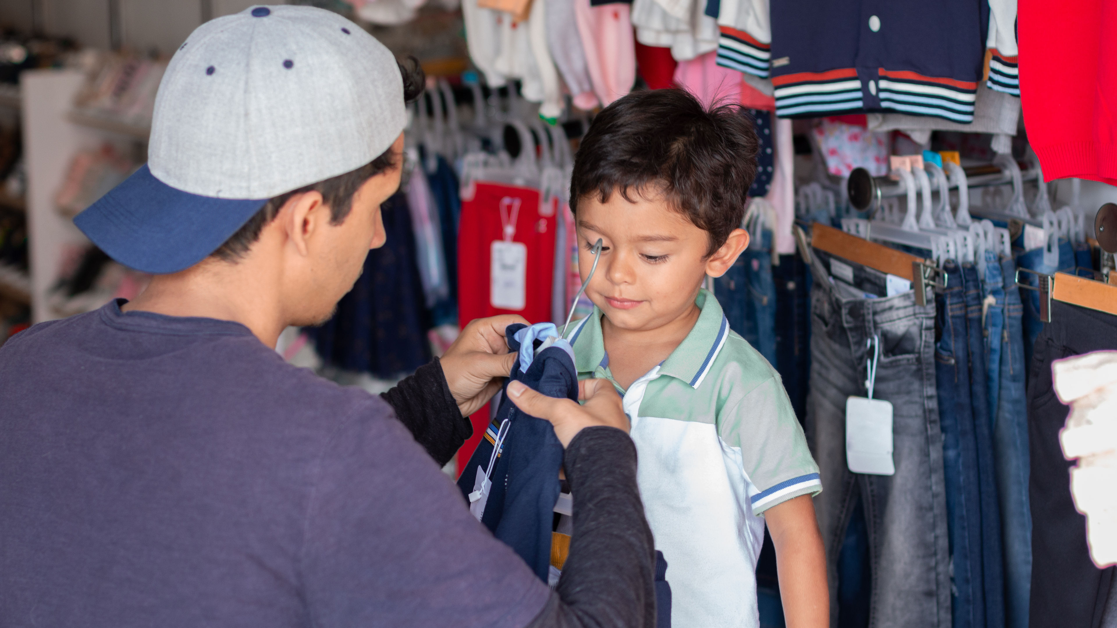 Adult buying clothes for his son