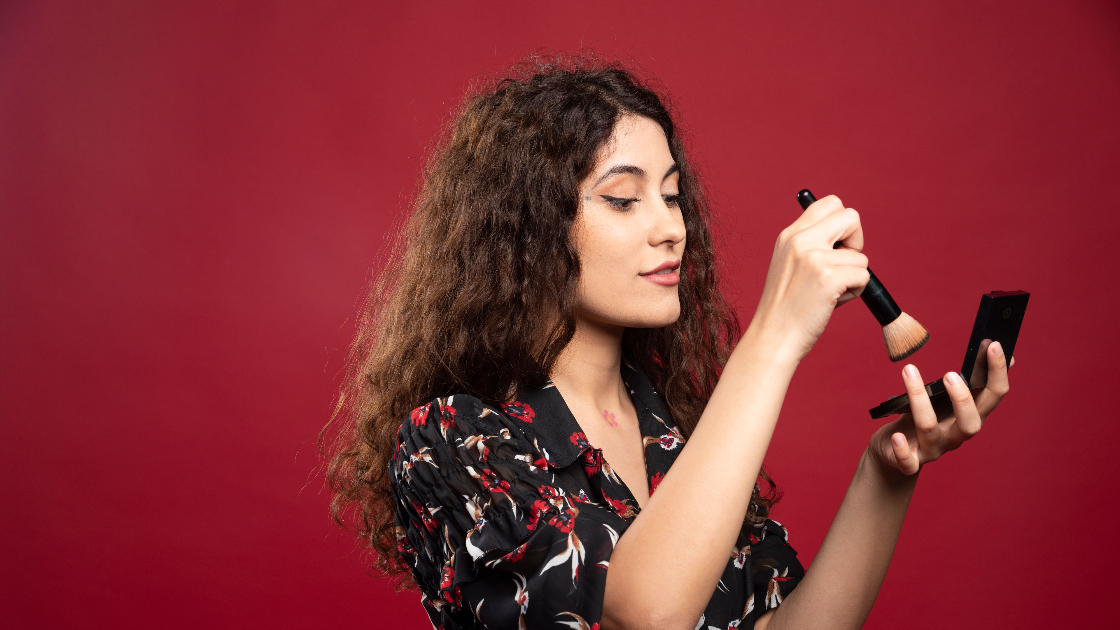 A woman applying a blush