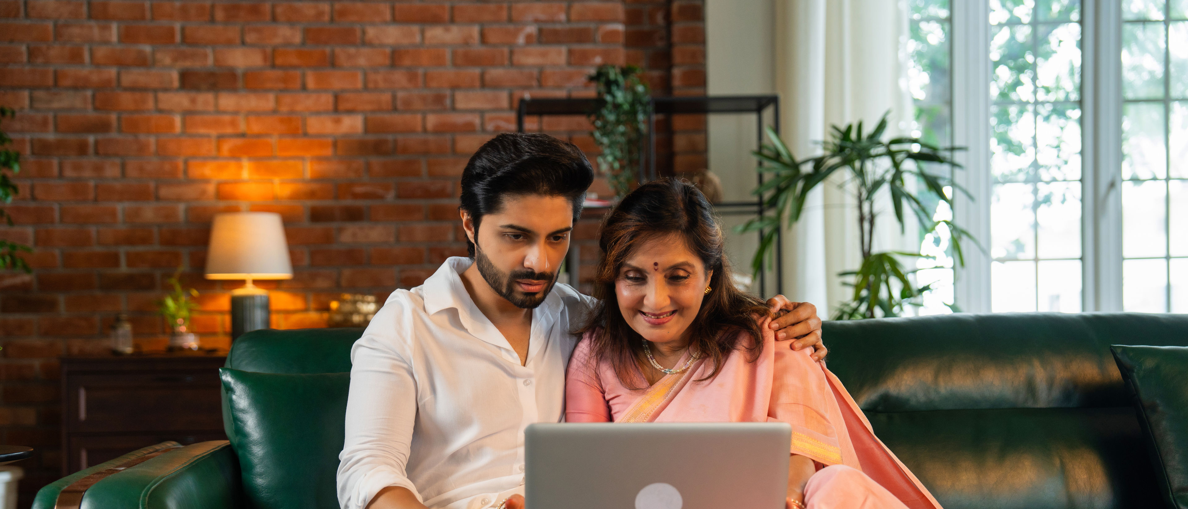 Mother and son using laptop