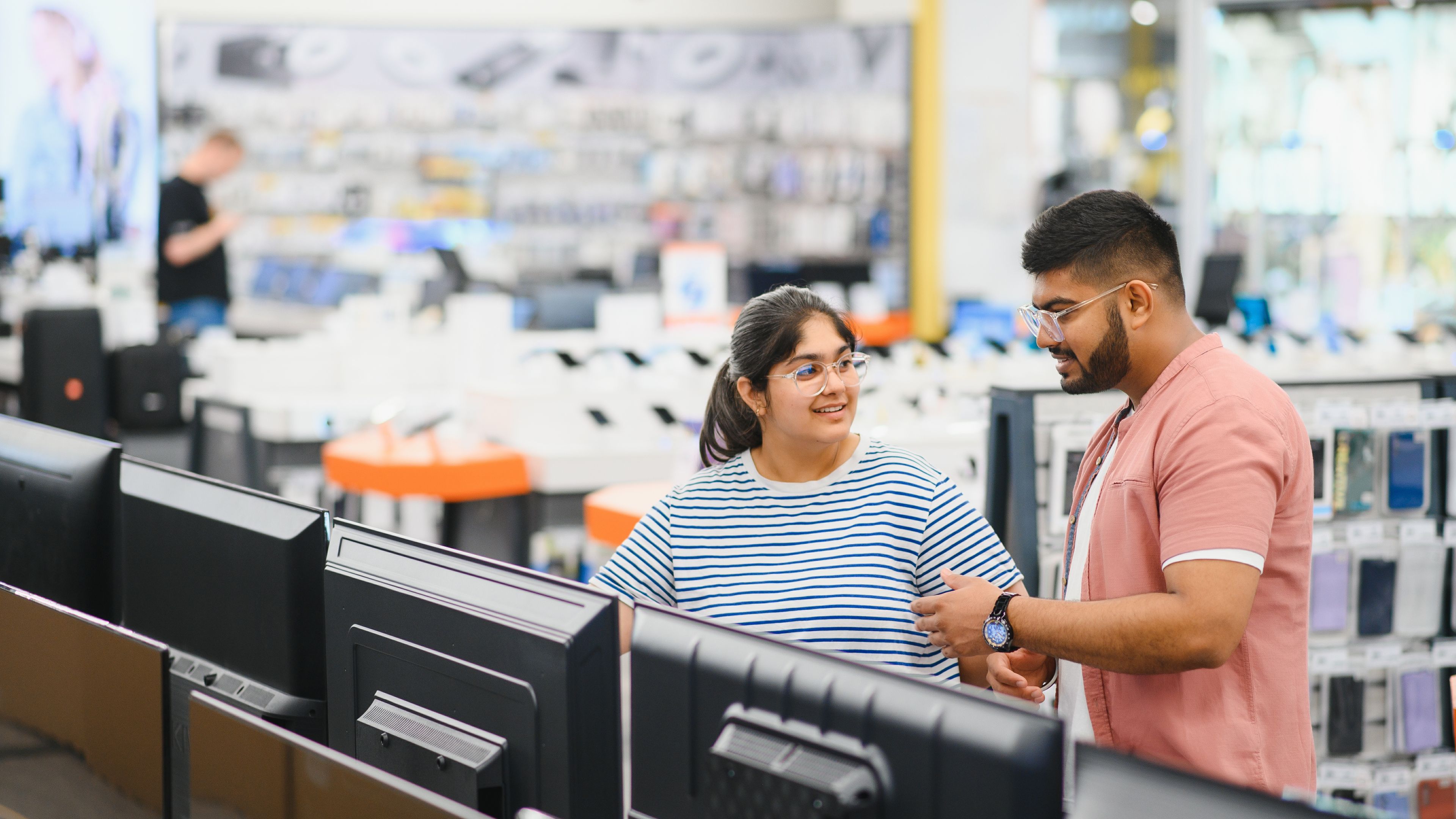 Two people in electronic shops