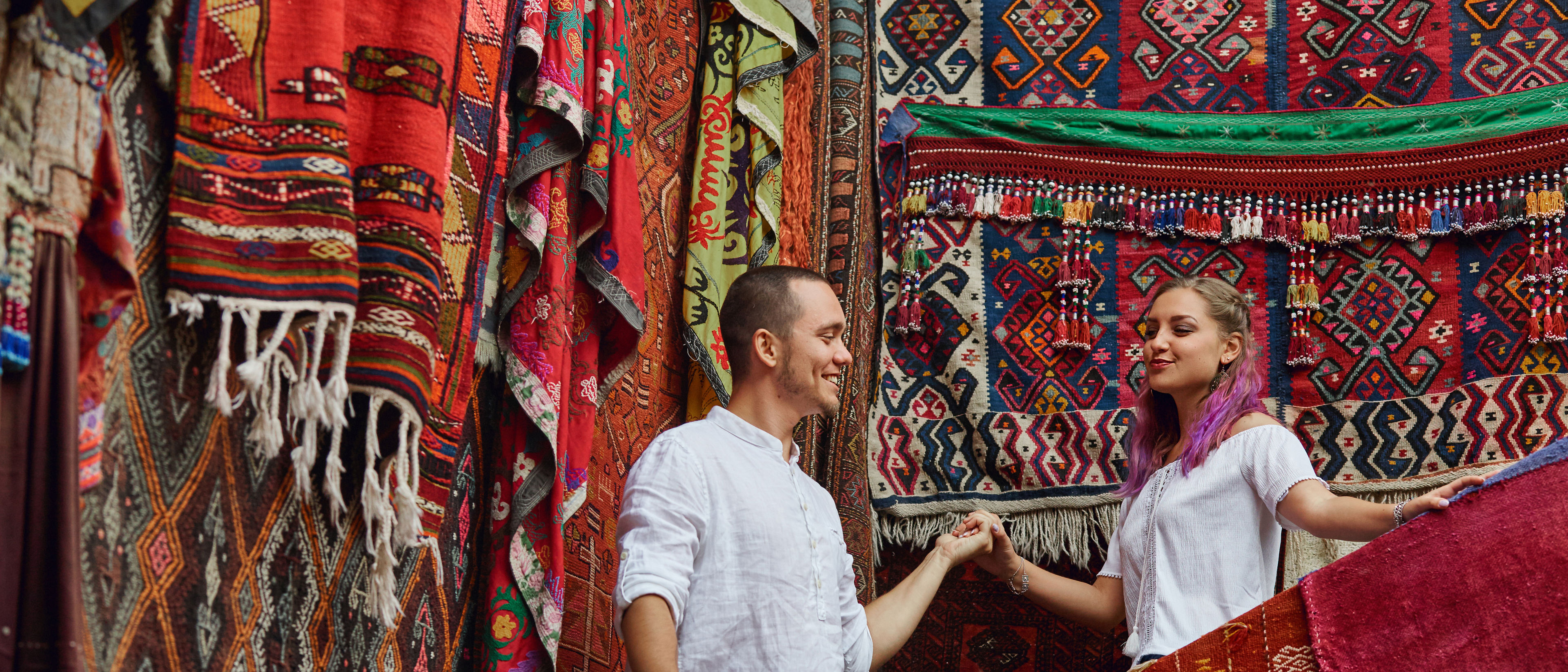 Couple in love chooses a Turkish carpet at the market cheerful joyful emotions