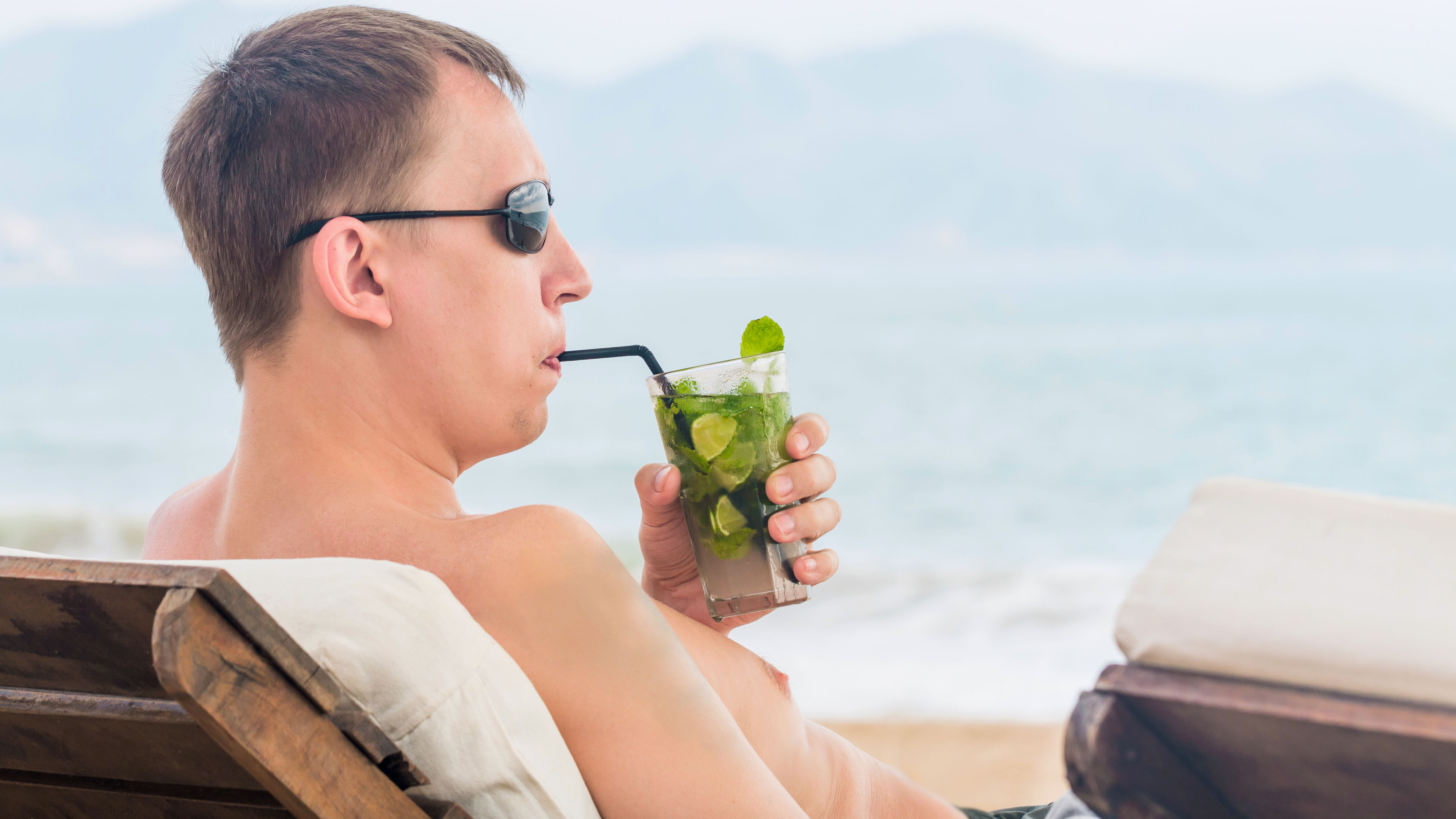 A man drinking cocktail.