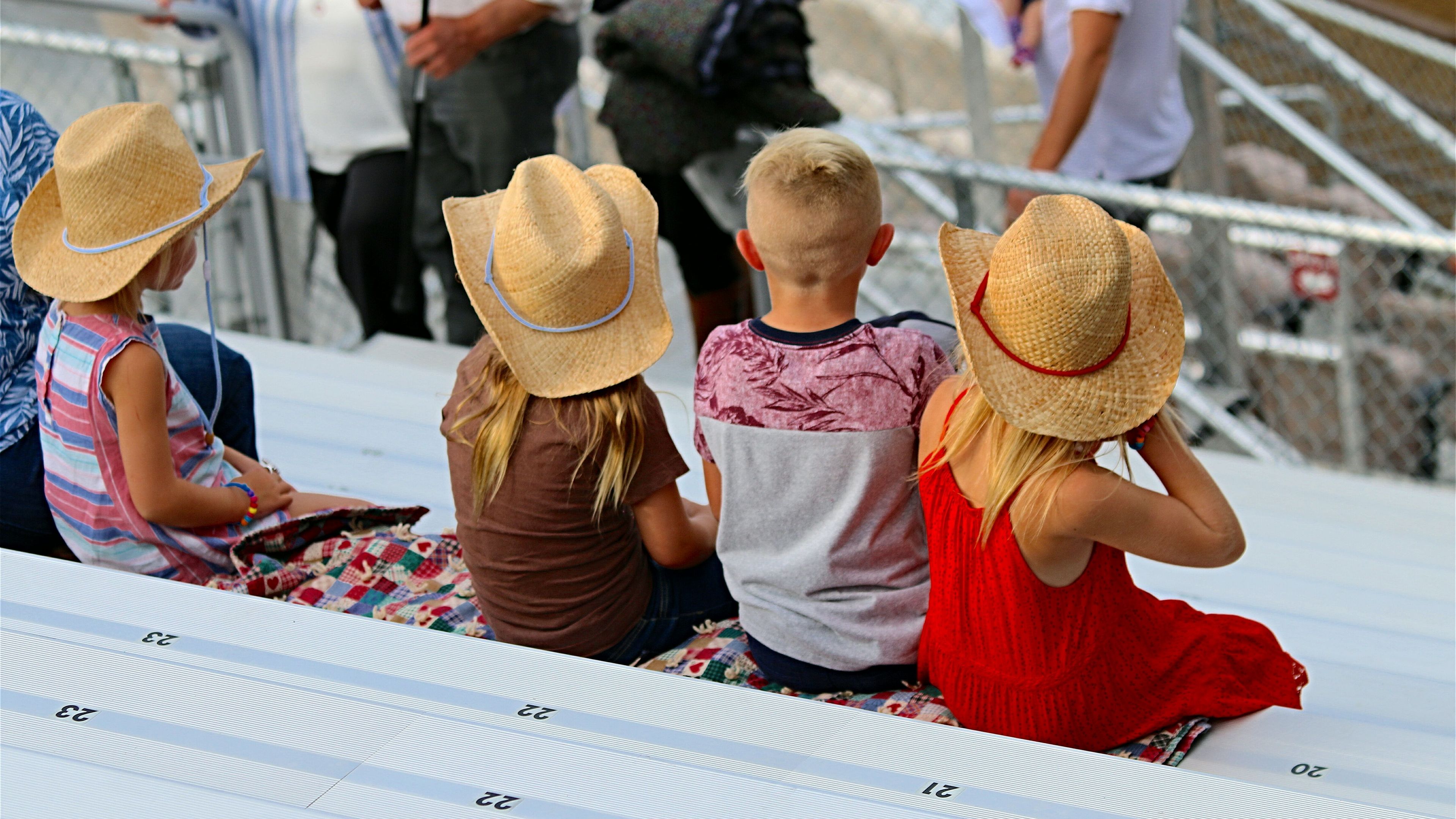 Children watching at a race venue.