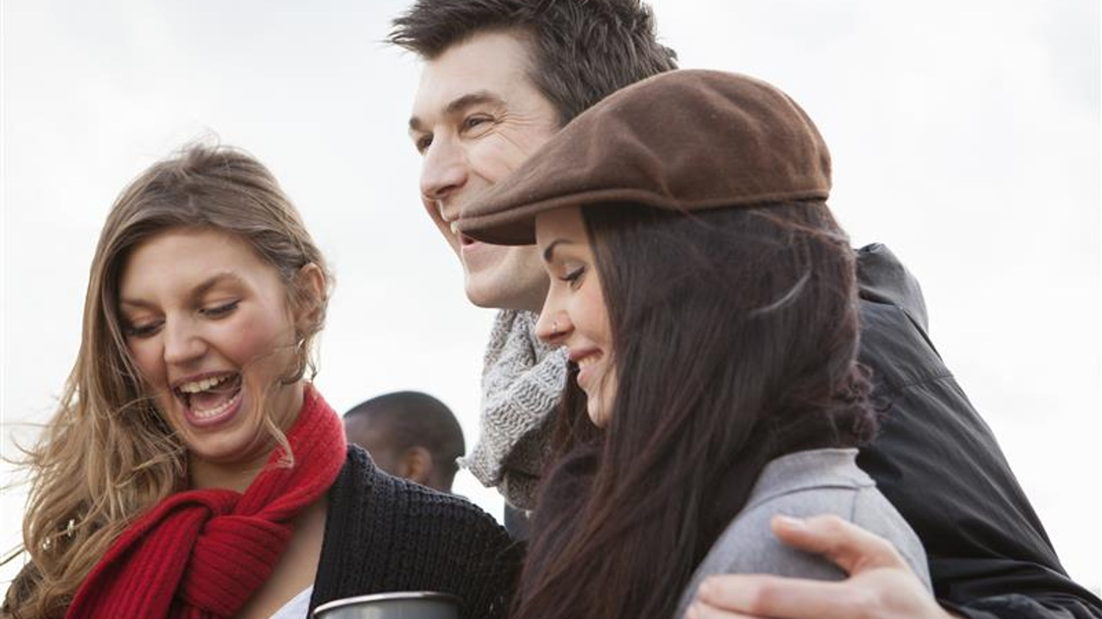 Friends sharing a laugh over warm drink