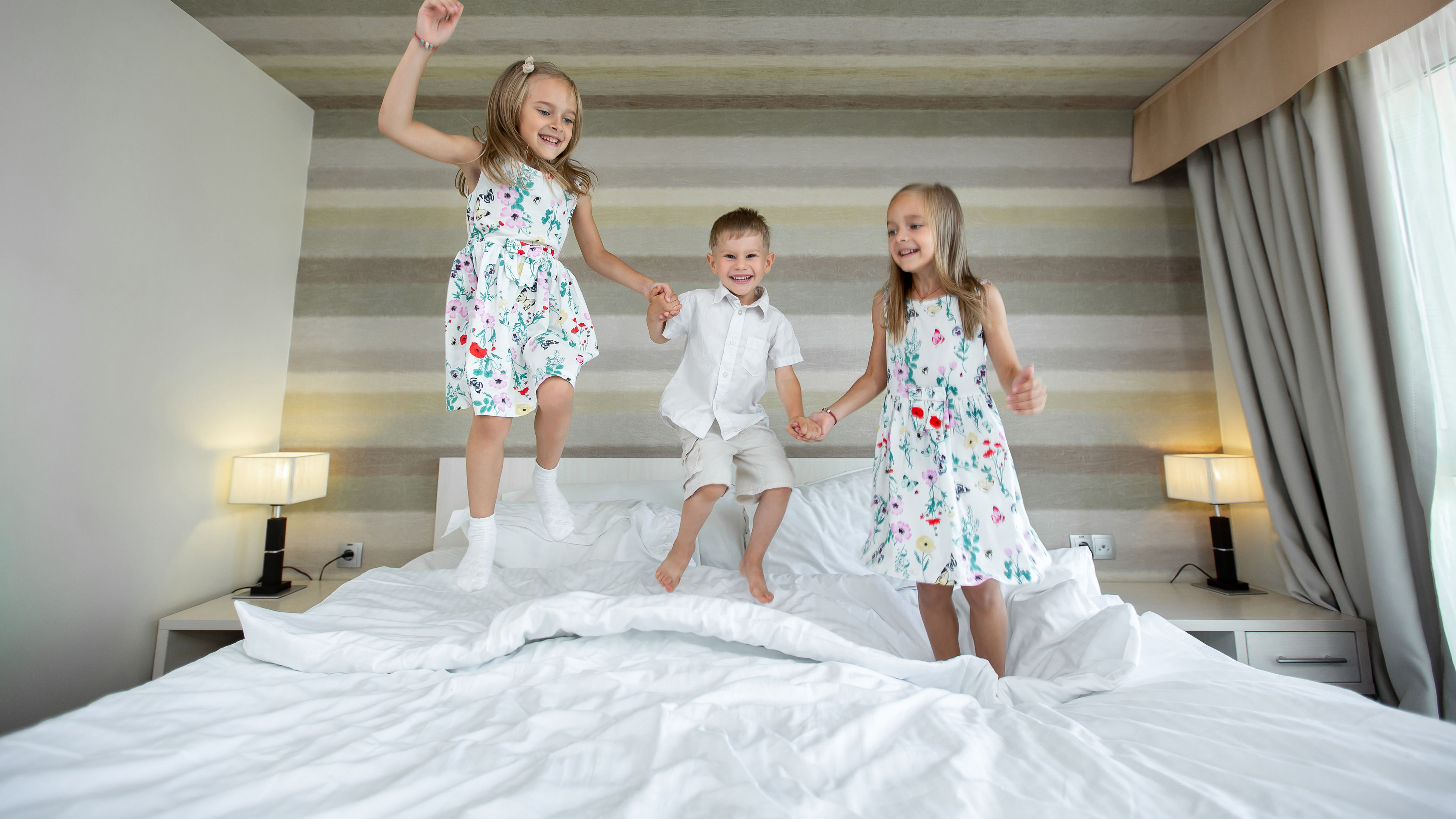 Kids playing in the bed