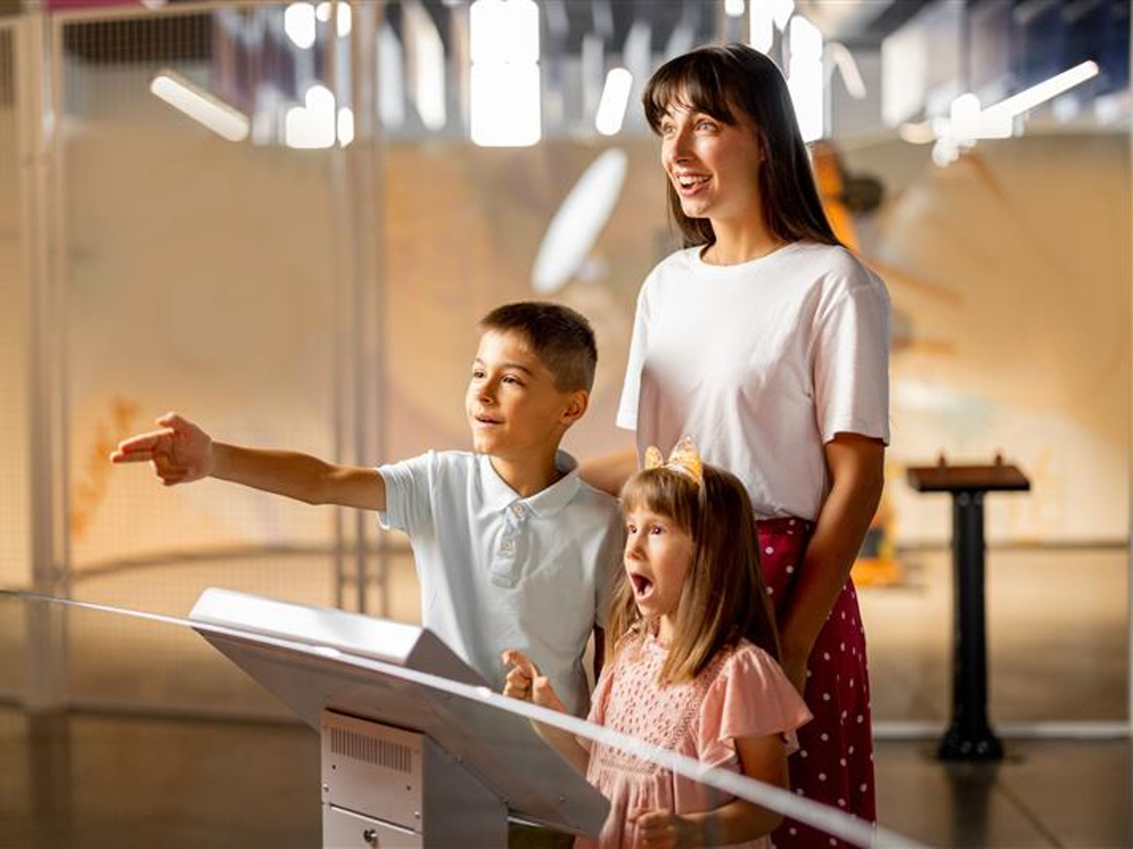 Mom with a kids interact with robot in science museum